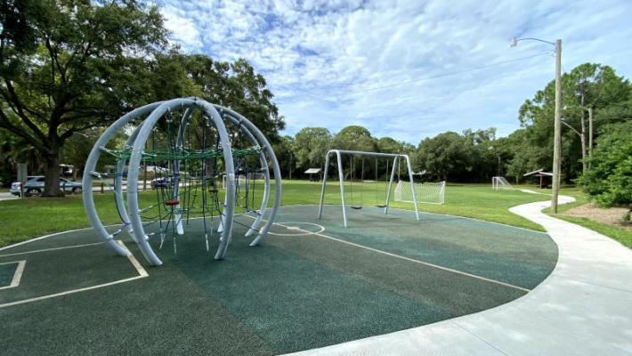 Eastwood Park - Come play at our soccer inspired park, complete with netted goals. Leashed pets allowed, swing set, covered picnic tables and playground. Photo